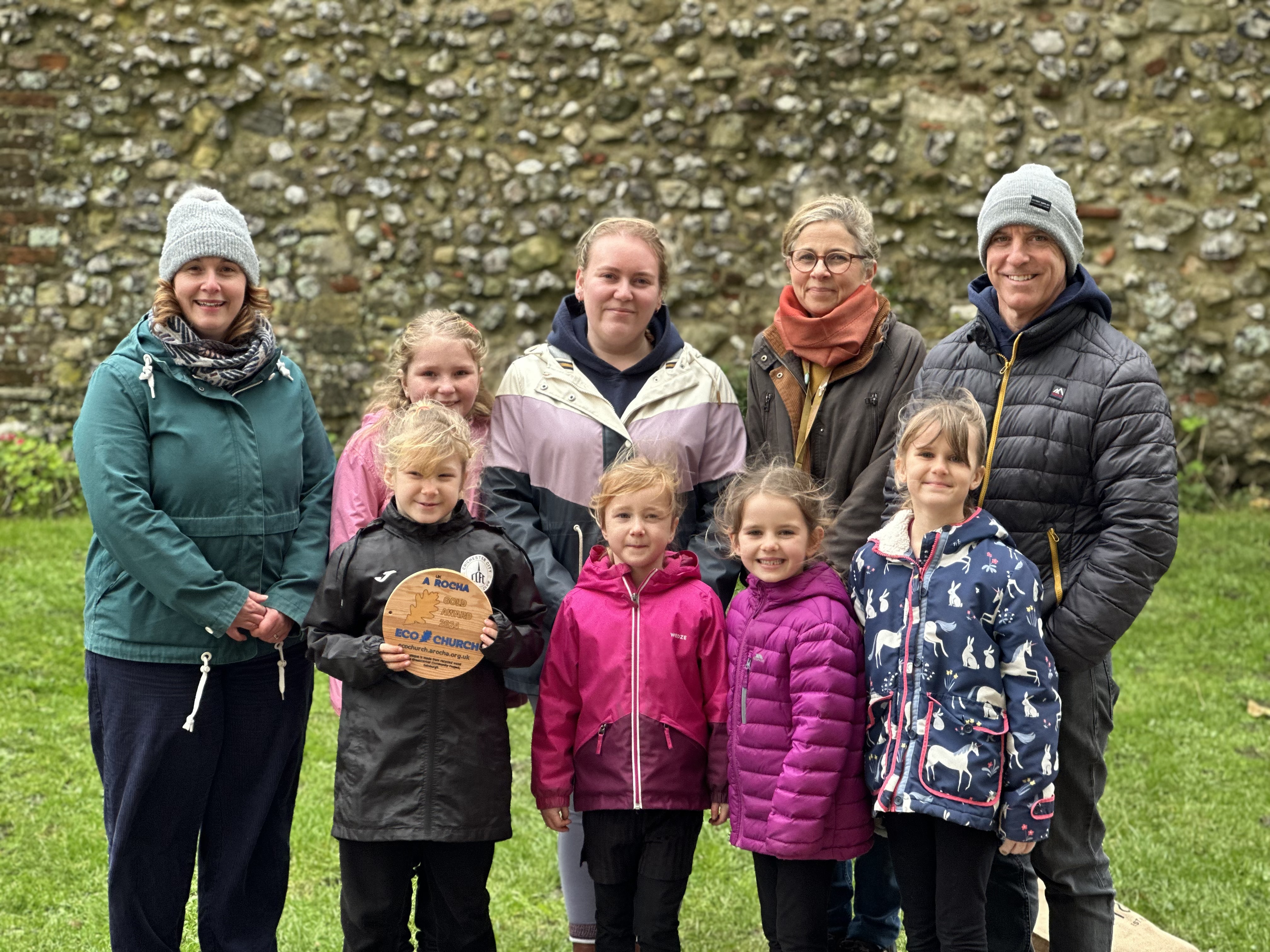 Pupils and teachers from Lavant CE Primary School pose with the Eco Church plaque, with Rosie Bradberry (Creative Learning Officer) and Vicky Sutton (Estates Co-ordinator)