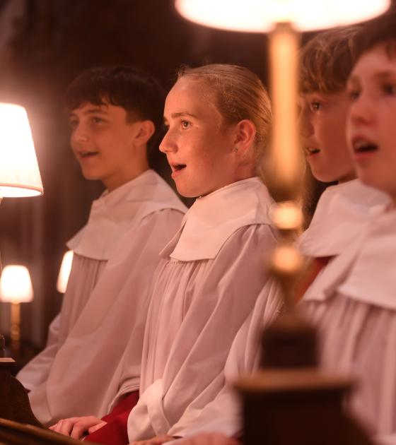 Three choristers in robes singing