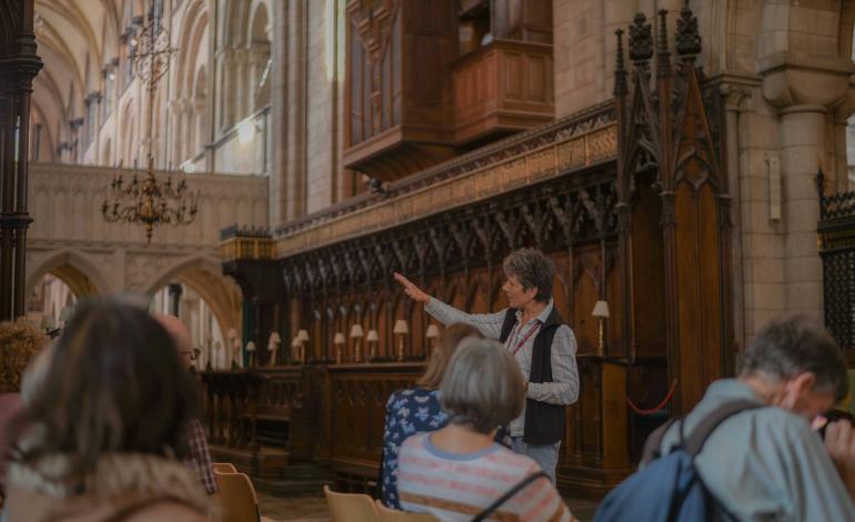 A guide gives a tour in the Quire