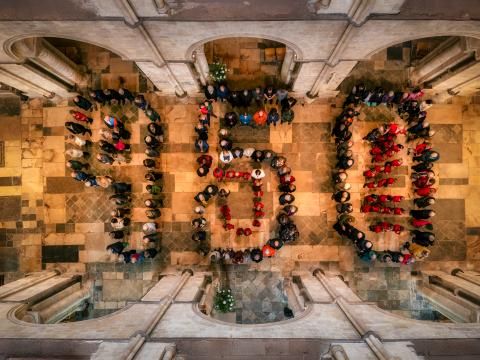 People stand in the shape of 950 in the Cathedral nave