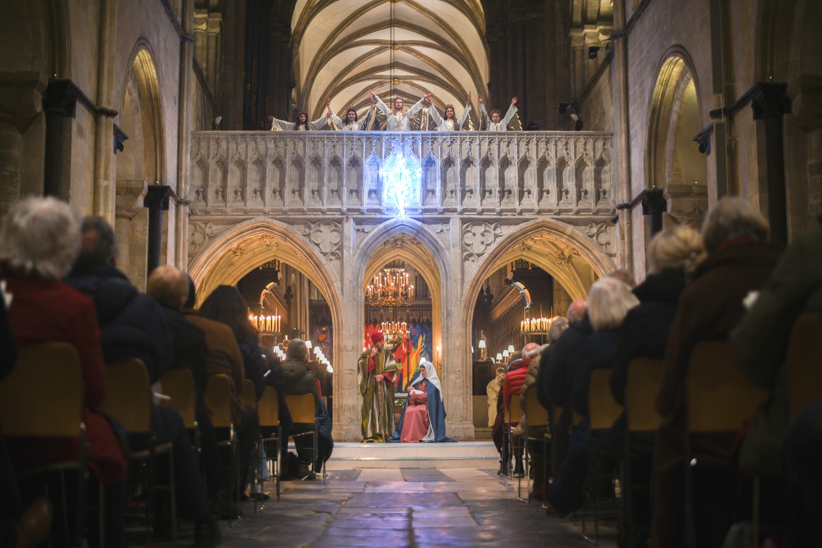 Angels appear on the Arundel Screen above a bright star. Mary, Joseph and Baby Jesus sit below